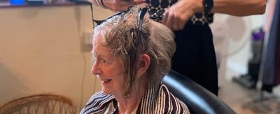 Senior woman getting a hair treatment at a salon