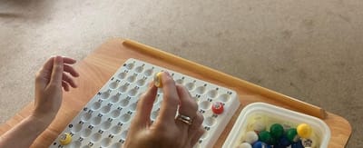 Hands participating in a bingo game activity.