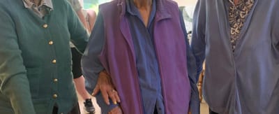 Three elderly residents in a common area