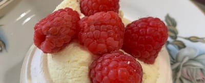 Dessert topped with fresh raspberries