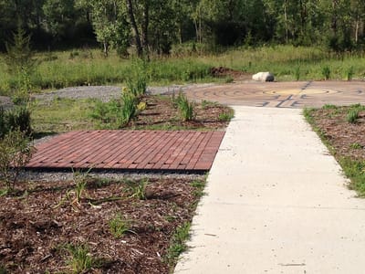 Outdoor pathway with garden and seating area
