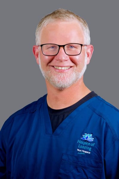 A smiling healthcare worker in scrubs