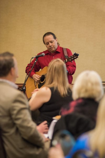 Musician performing in a common area event.
