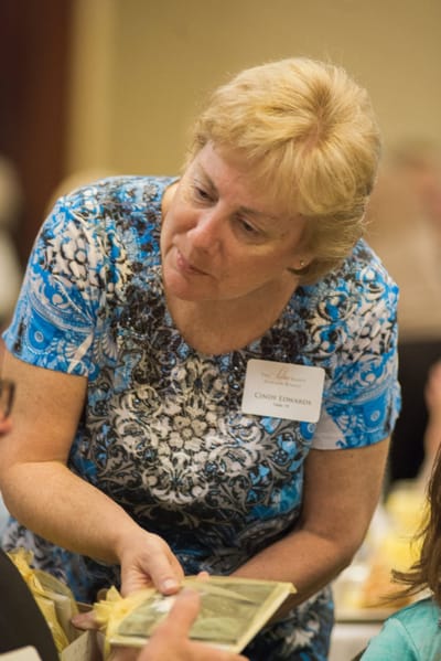 Staff member interacting with a resident at an event.