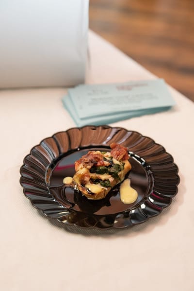 Gourmet food plated elegantly on a black dish.