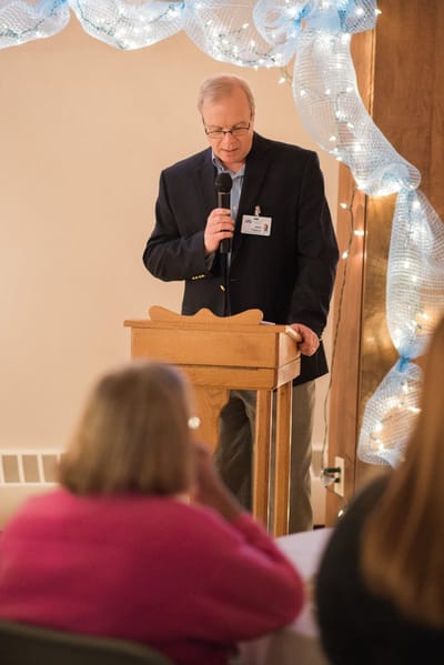 A speaker addresses residents at an event.