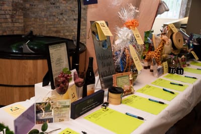 Table set up for an event with decorations and gifts.