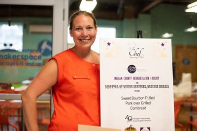Woman smiling at a food service event