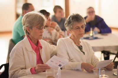Two female residents engaged in a gathering