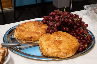 Platters of baked goods and grapes on a table