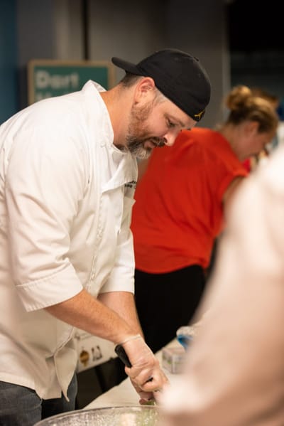 Staff preparing food in a kitchen setting