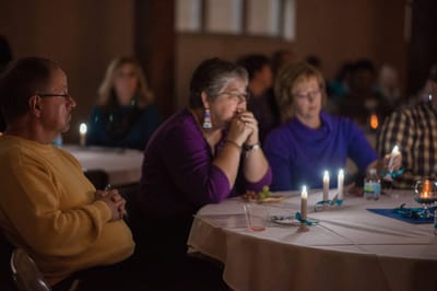 Residents engaged in a thoughtful discussion at a gathering.