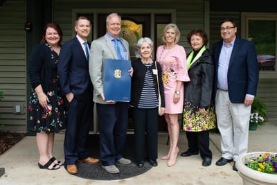Group of people celebrating with a resident.