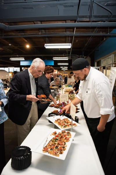 Residents enjoying a food tasting event.