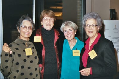 Group of smiling women at a facility event.