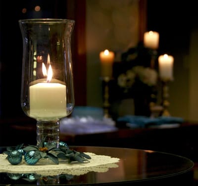 A lit candle on a decorative table setting