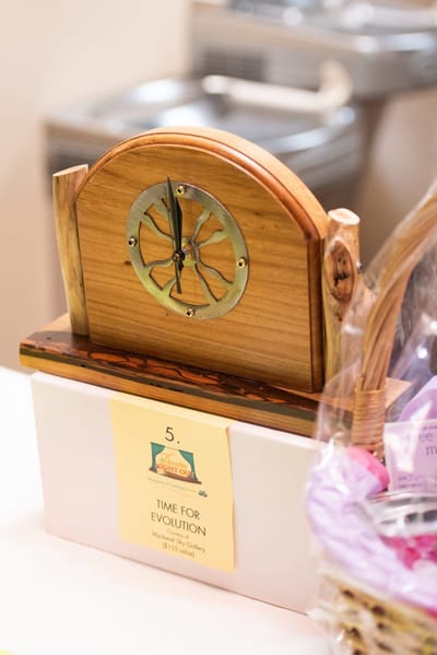 Wooden clock displayed on a table.