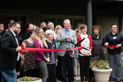 Ribbon-cutting ceremony with staff and community members.