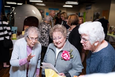 Residents engaging in a social event indoors.