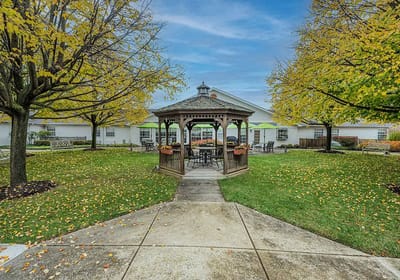 Outdoor gazebo surrounded by colorful trees in a senior living community
