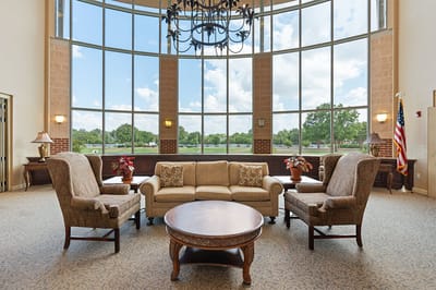 Bright common area with seating and large windows