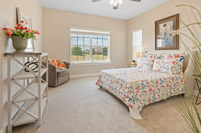 Cozy resident room with floral bedspread and natural light