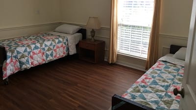 Brightly lit shared bedroom with twin beds