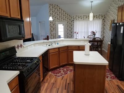 Bright kitchen area with wooden cabinets and dining table