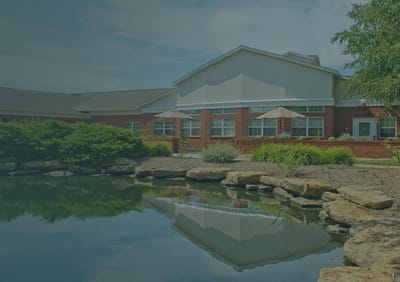Exterior view of Wilshire rehab center by a pond