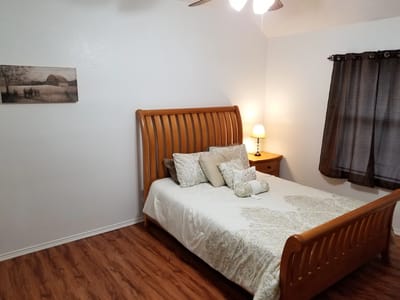 Cozy bedroom with a wooden bed and decorative pillows