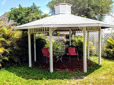 Outdoor gazebo with seating in a garden