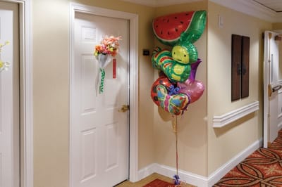 Colorful balloons at a resident's door