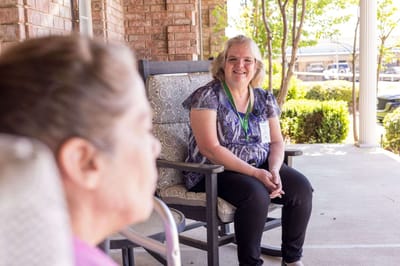 Staff member interacting with a resident outdoors