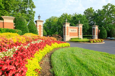 Entrance of AdamsPlace with landscaped flowers and signage