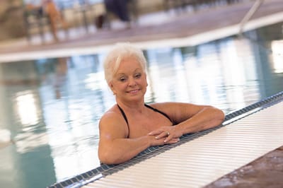 A senior woman enjoying a swim in the pool