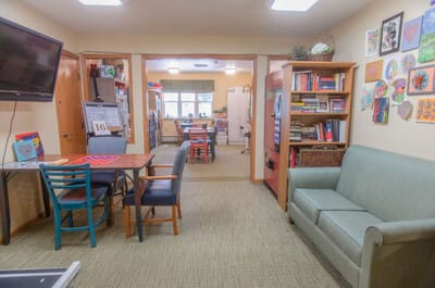 Bright activity room with seating and artwork