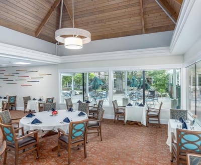 Bright dining room with large windows and table settings