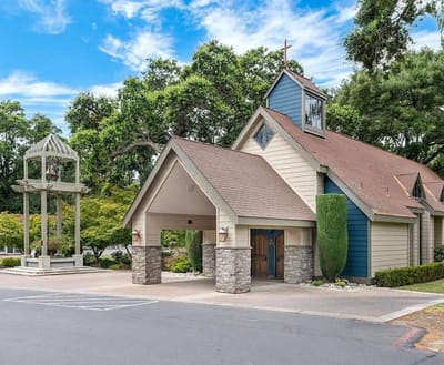 Exterior view of a charming chapel with a bell tower