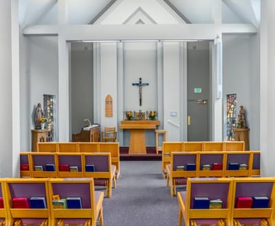 Interior view of a chapel with wooden seating