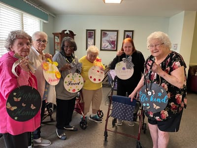 Residents displaying handmade signs in a common area