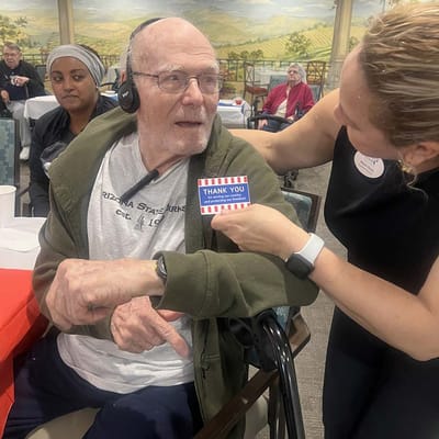Residents enjoying an activity with staff assistance
