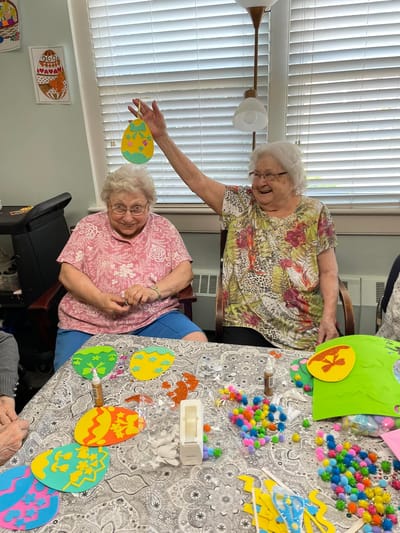Residents engaging in a crafting activity with colorful materials
