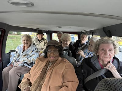 Residents enjoying a ride in a facility vehicle