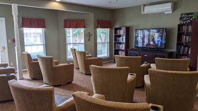 Comfortable seating area in a common room with a TV