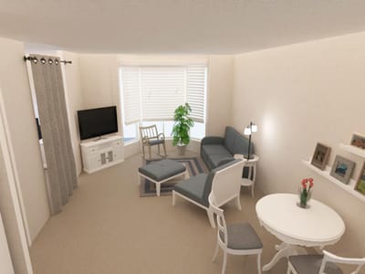 A cozy resident room with seating and a TV