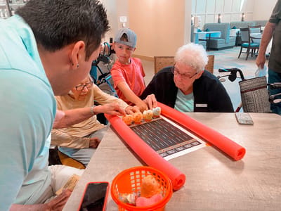 Residents enjoying a game with donuts in a common area