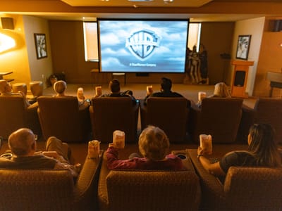 Residents enjoying a movie in a common area