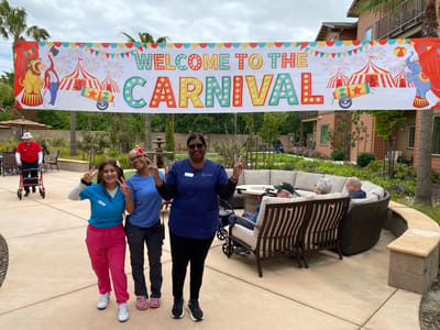 Staff and residents enjoying carnival festivities in the courtyard.