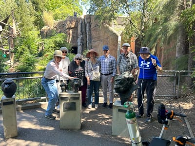 Residents enjoying an outdoor activity with sculptures