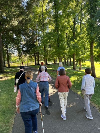 Residents enjoying a walk in a lush green park